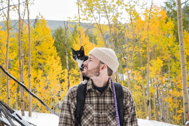 Photo by Chewy on Unsplash- man with cat on shoulder